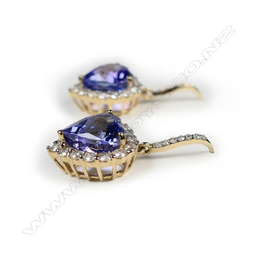 A pair of 14ct gold tanzanite and diamond halo earrings Image 1++