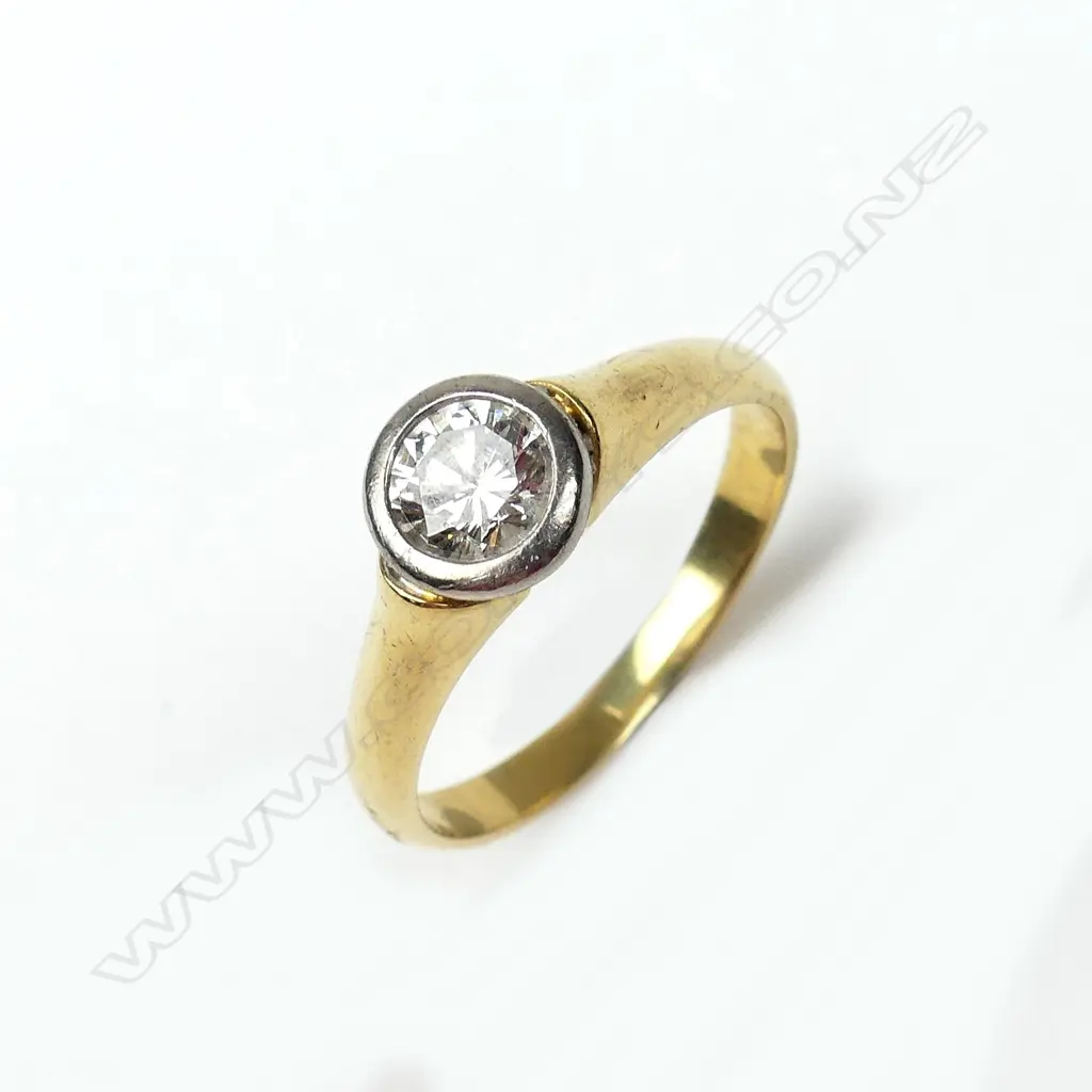 An 18ct yellow and white gold solitaire diamond ring Image 1++