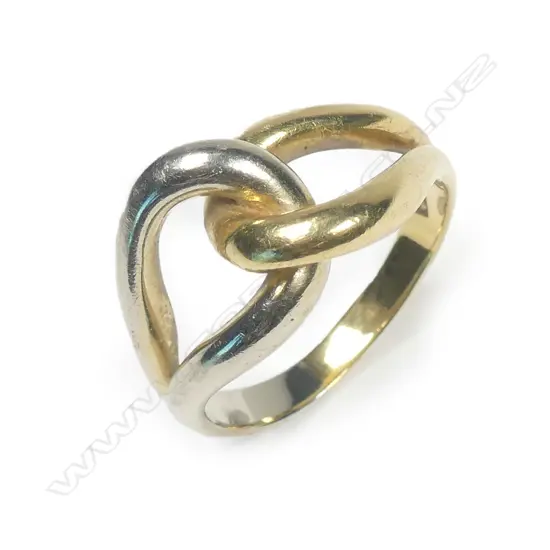 An NZ designer 18ct gold ring, with substantial yellow and white gold looping links. Stamped jewellers monogram AT. 10gm.