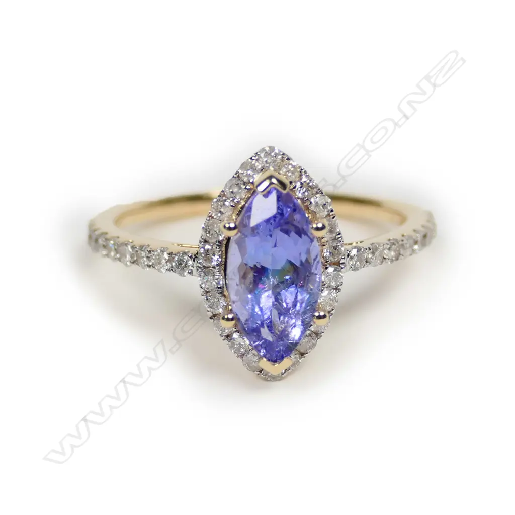 A 14ct gold tanzanite and diamond halo ring Image 1++