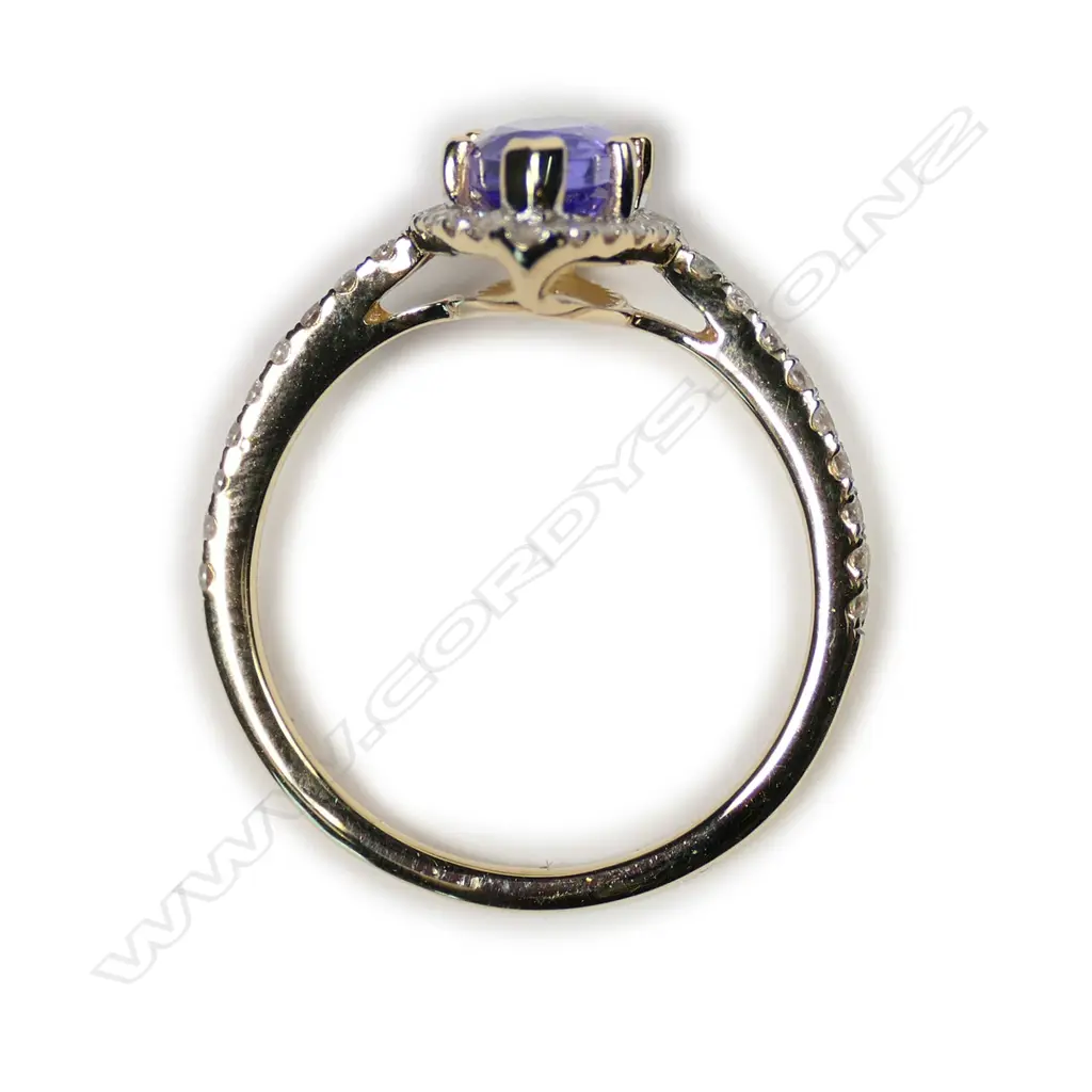 A 14ct gold tanzanite and diamond halo ring Image 1++