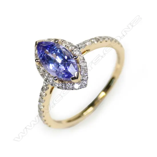 A 14ct gold tanzanite and diamond halo ring