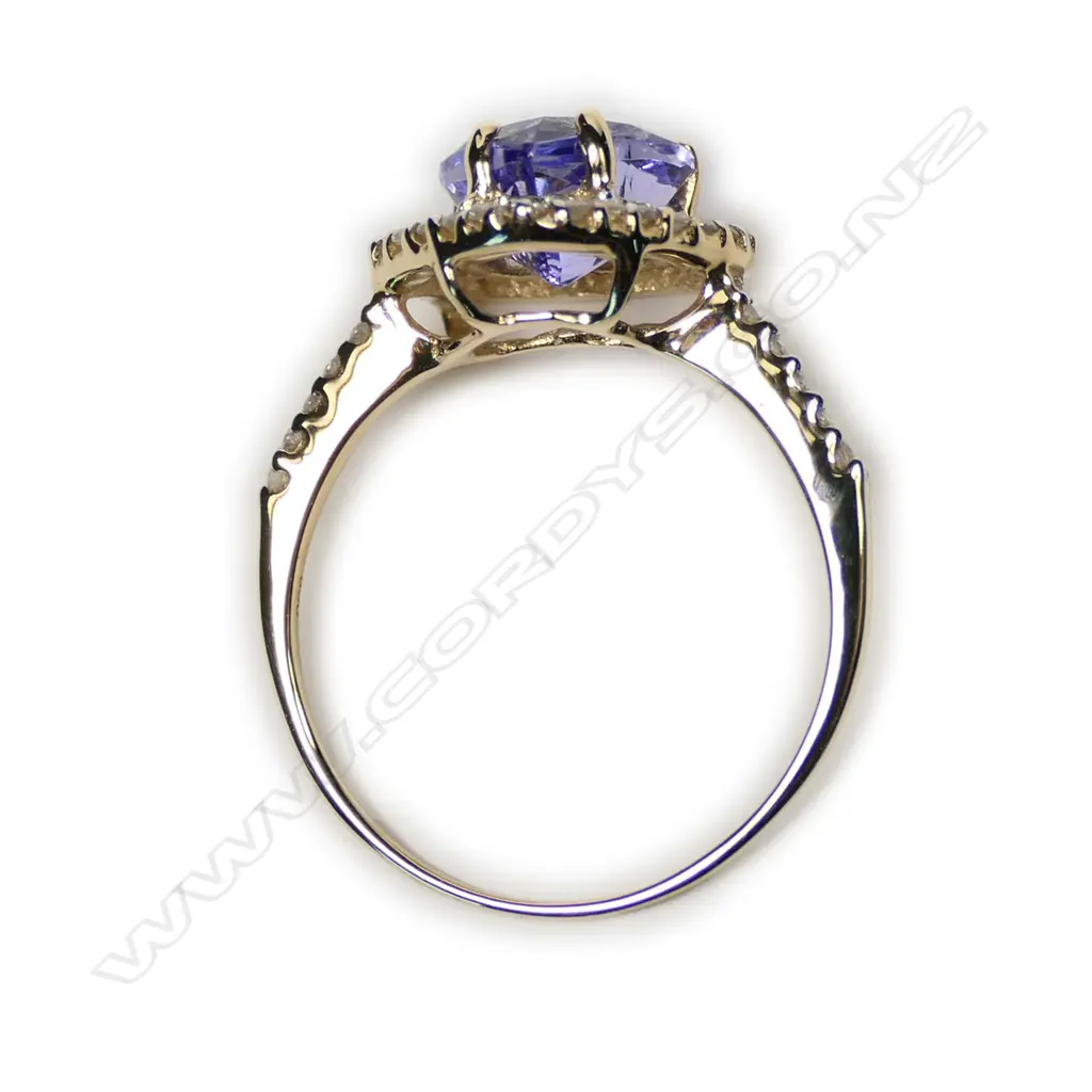 A 14ct gold tanzanite and diamond halo heart ring Image 1++