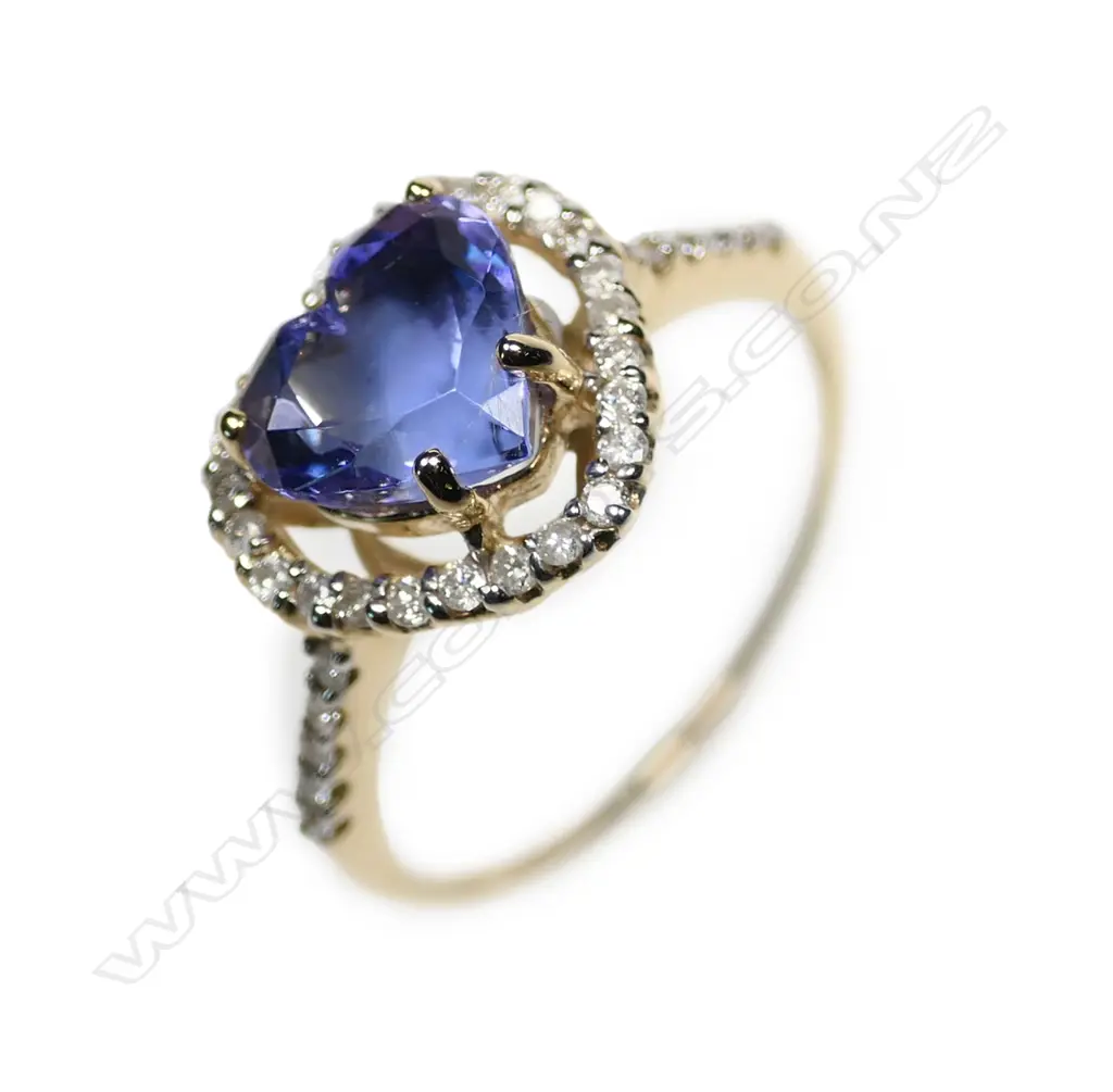 A 14ct gold tanzanite and diamond halo heart ring Image 1++