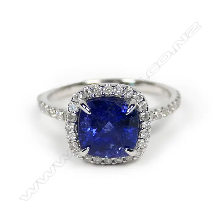 A 14ct white gold tanzanite and diamond halo ring Image 1++