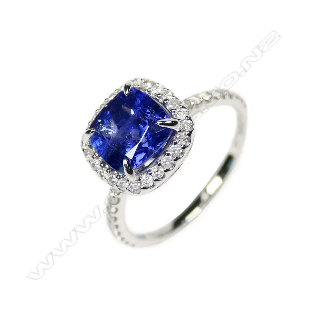 A 14ct white gold tanzanite and diamond halo ring Image 1++