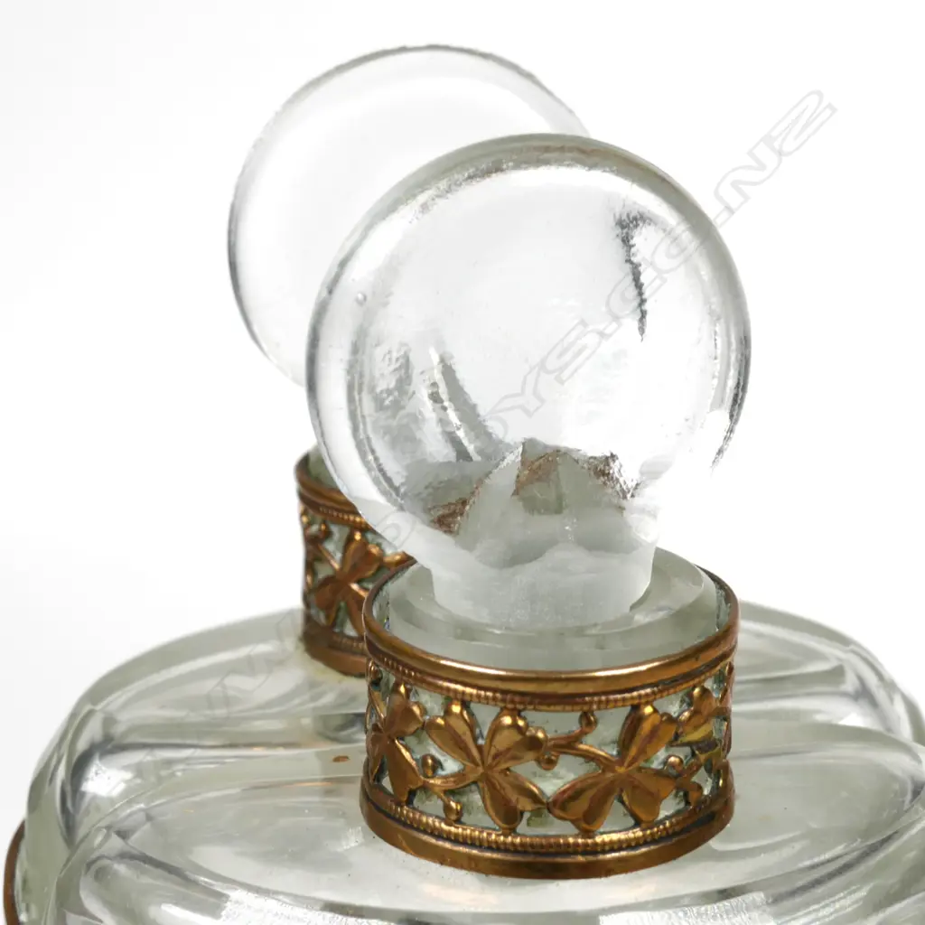 A pair of early 1900s glass perfume bottles in brass holder Image 1++