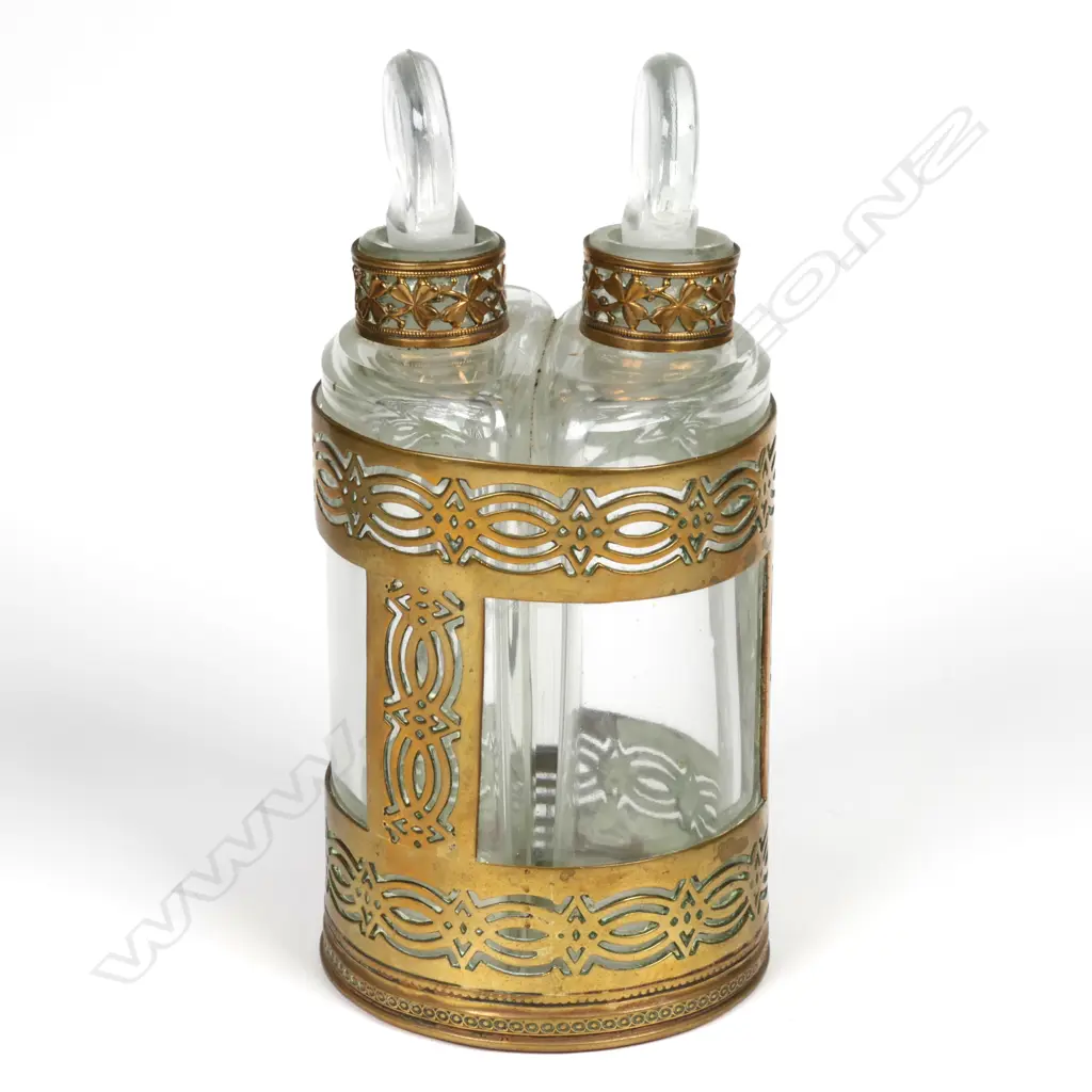 A pair of early 1900s glass perfume bottles in brass holder Image 1++