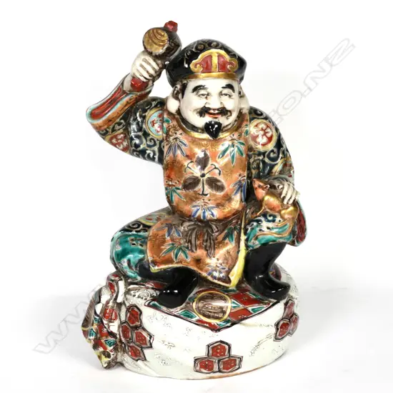 A Japanese Kutani pottery figure of Daikoku