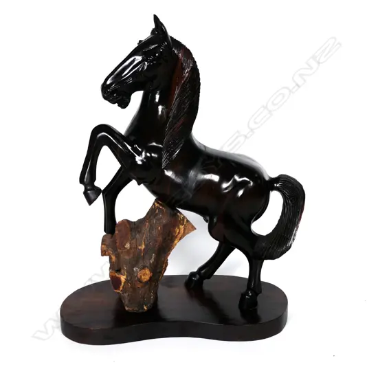 A large carved ebony rearing horse