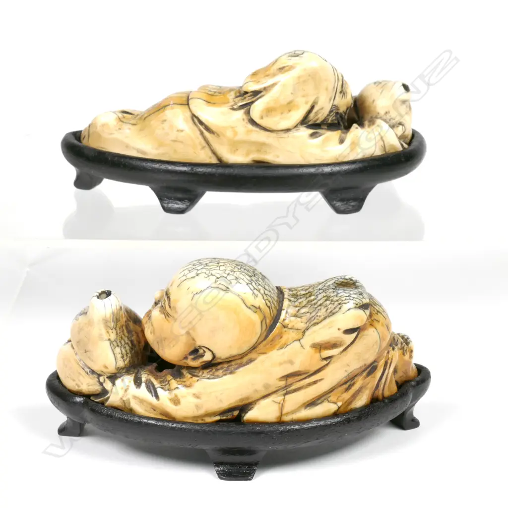 A pair of carved mammoth ivory figures Image 1++