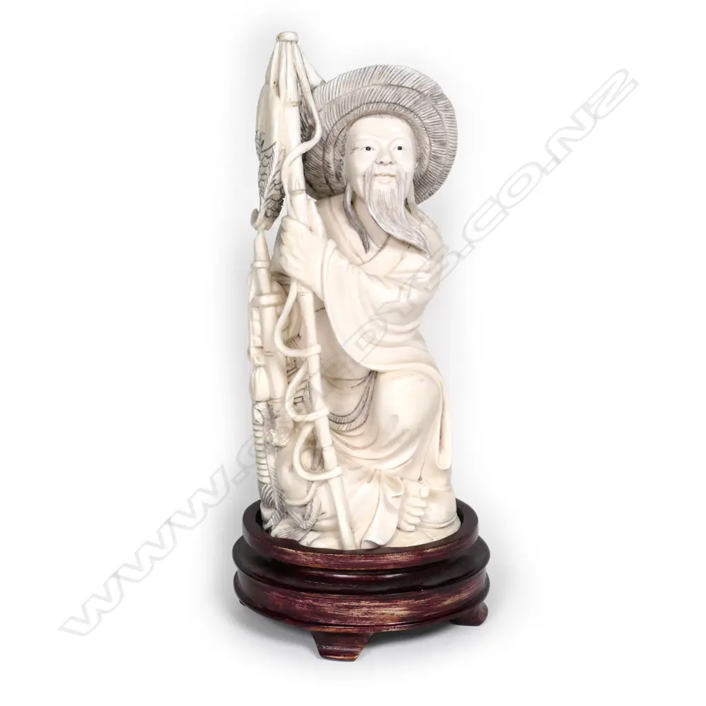 A Chinese carved ivory fisherman on stand Image 1++