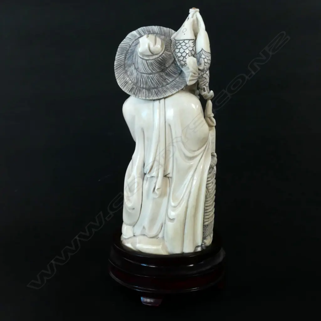 A Chinese carved ivory fisherman on stand Image 1++