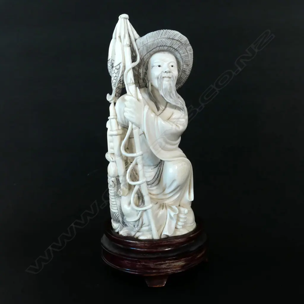 A Chinese carved ivory fisherman on stand Image 1++