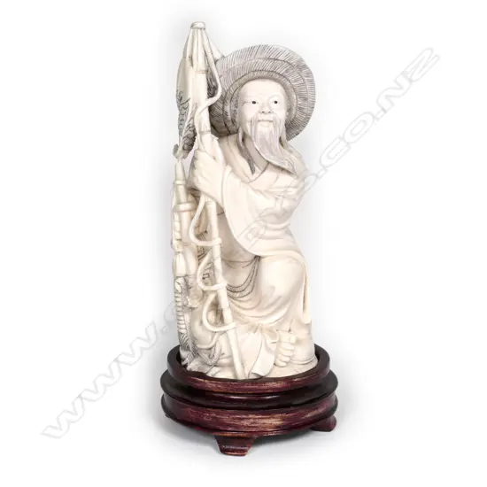 A Chinese carved ivory fisherman on stand