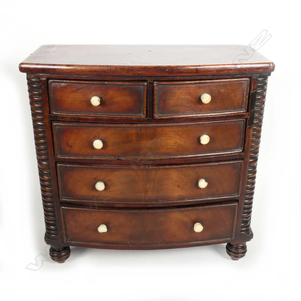 A Georgian mahogany miniature bowfront chest of drawers Image 1++