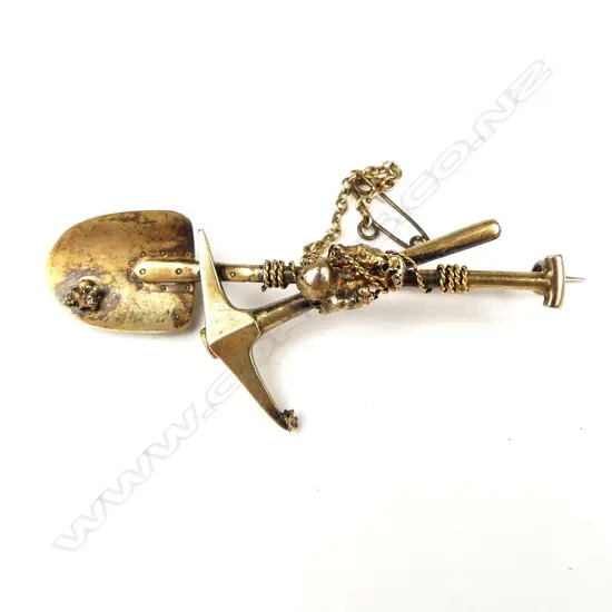 A c.1900 gilded 9ct. yellow gold miner's sweetheart pick-and-shovel brooch