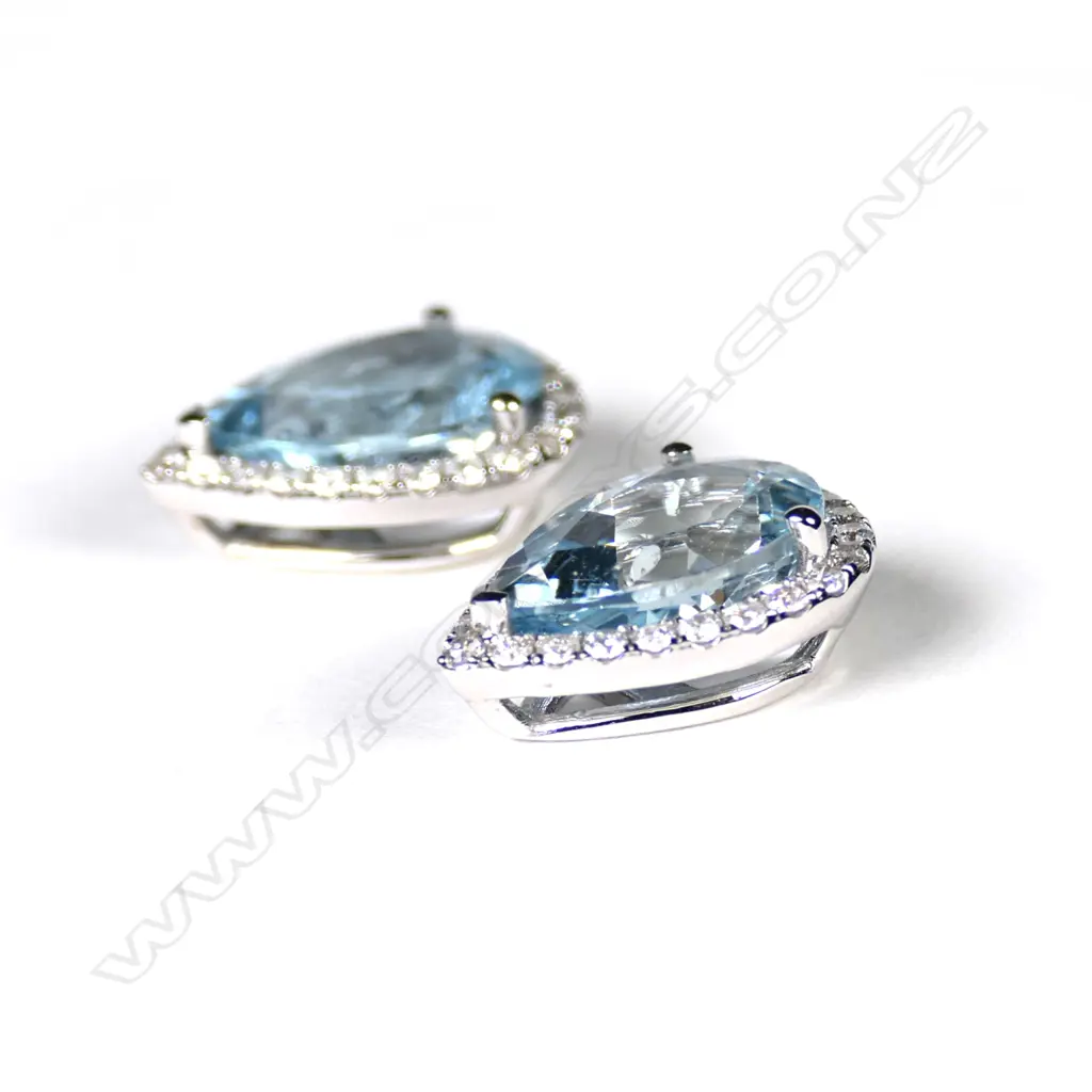 A pair of 14ct white gold aquamarine and diamond halo earrings Image 1++