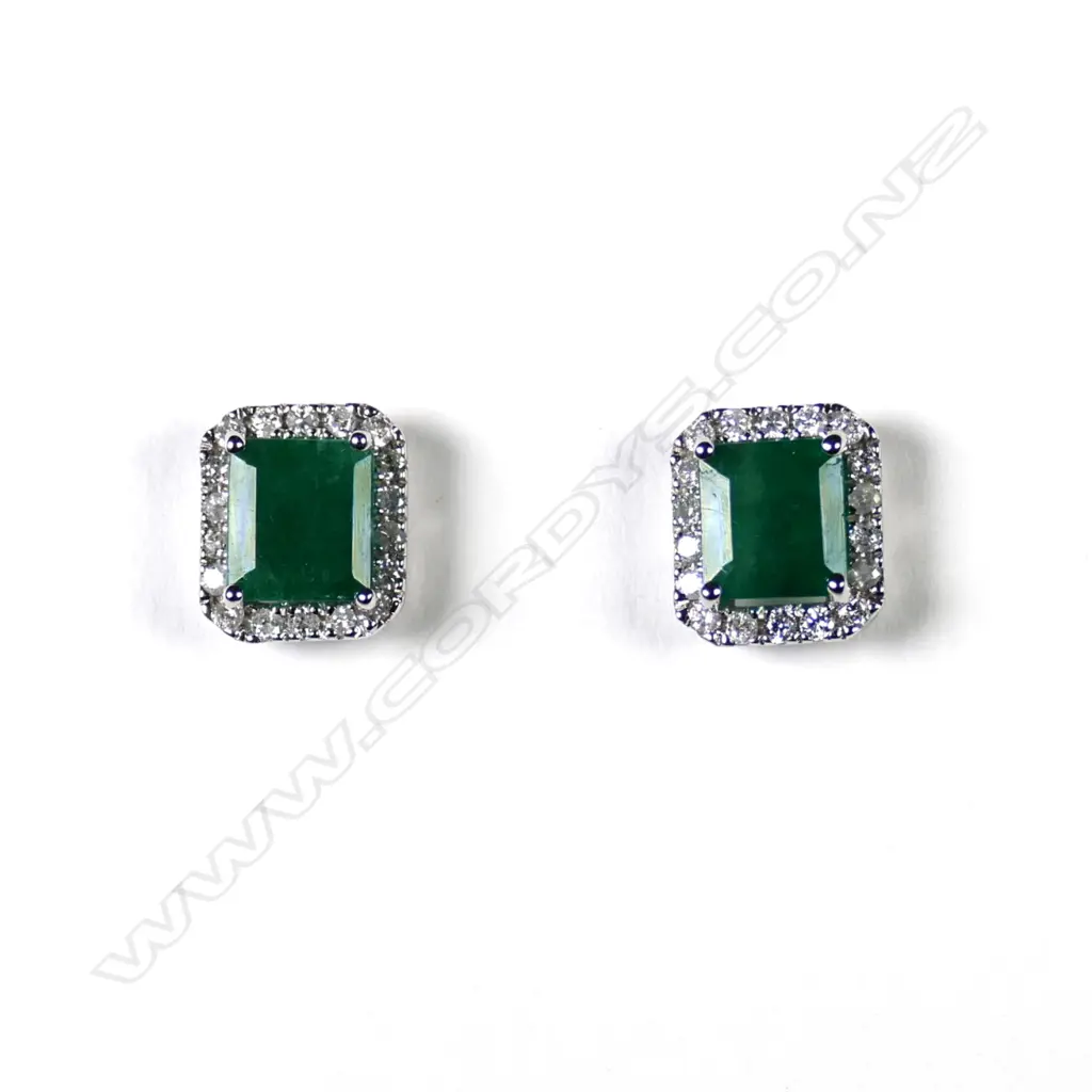 A pair of 14ct white gold emerald and diamond stud halo earrings Image 1++