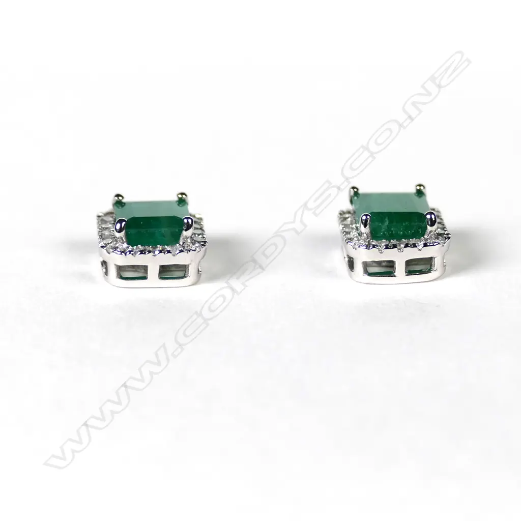 A pair of 14ct white gold emerald and diamond stud halo earrings Image 1++