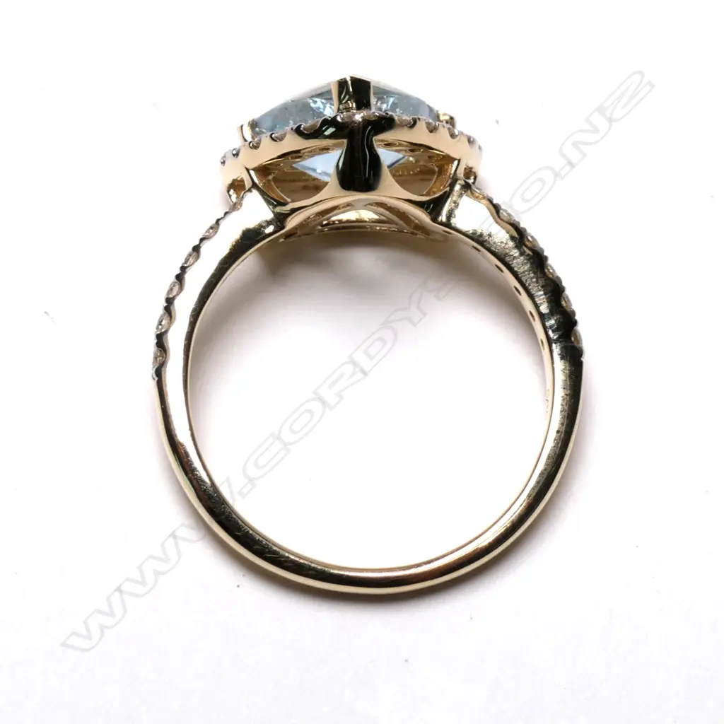 A 14ct yellow gold aquamarine and diamond halo ring Image 1++