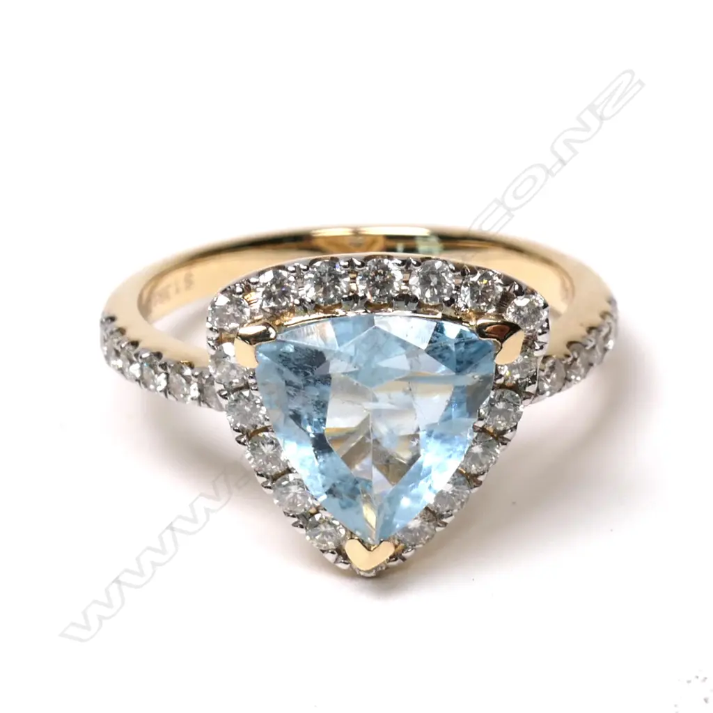 A 14ct yellow gold aquamarine and diamond halo ring Image 1++