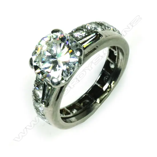 A 2ct diamond solitaire ring together with joined companion eternity band