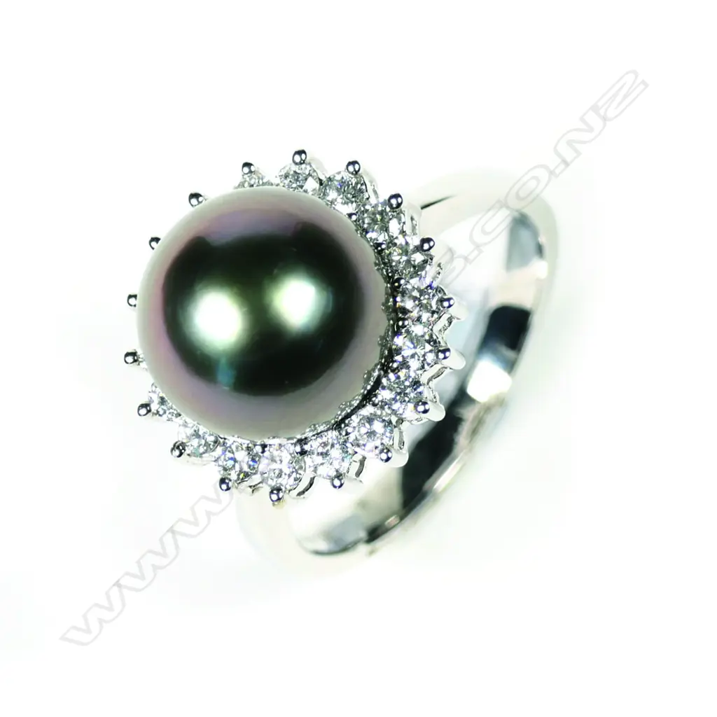 A modern 18ct white gold pearl and diamond ring Image 1++