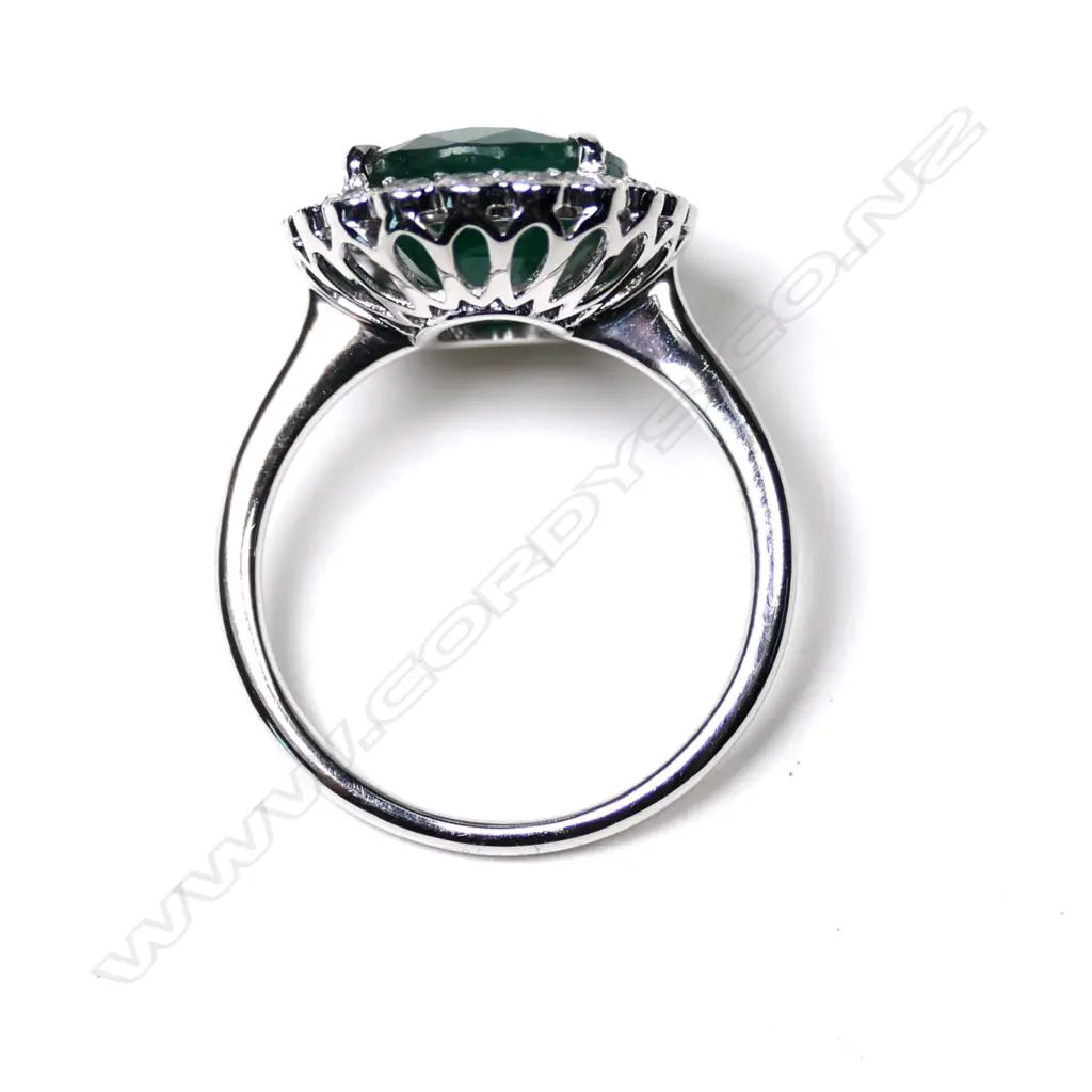A 14ct white gold emerald and diamond halo ring Image 1++