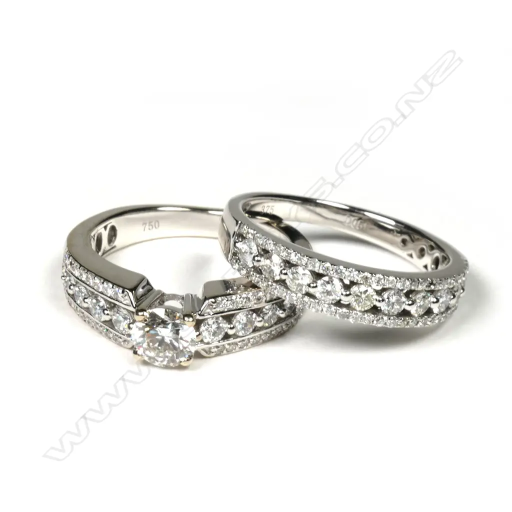 A pair of modern 18ct and 9ct white gold and diamond wedding and engagement rings Image 1++