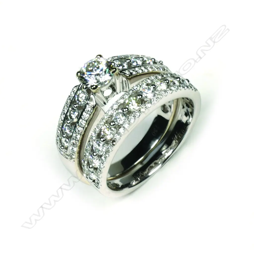 A pair of modern 18ct and 9ct white gold and diamond wedding and engagement rings Image 1++