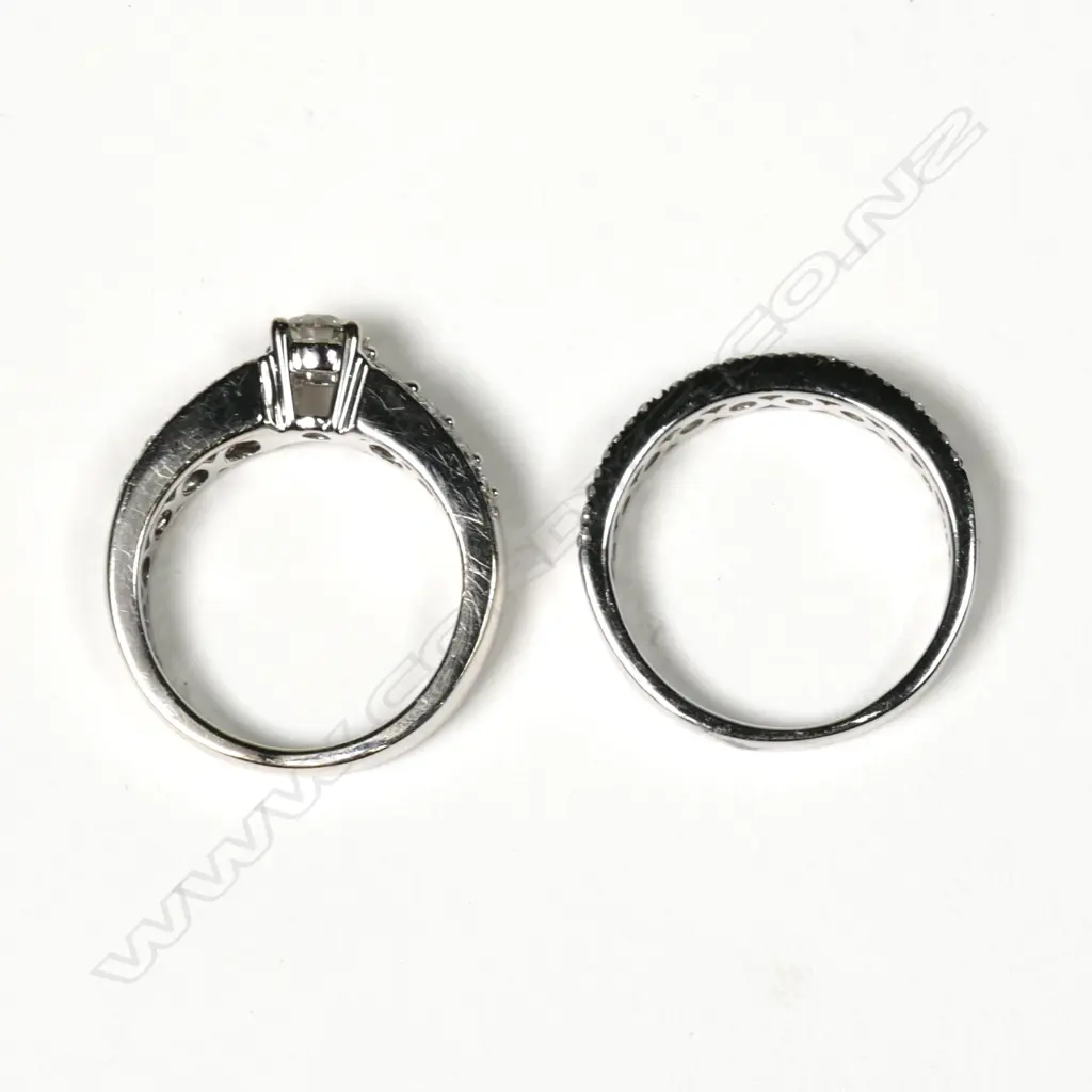 A pair of modern 18ct and 9ct white gold and diamond wedding and engagement rings Image 1++