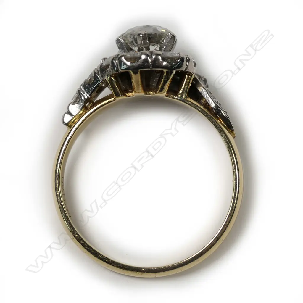 An 18ct gold, diamond solitaire cross-over ring, the central 0.82ct early round brilliant cut graded I-J and I1, framed by 17 further diamonds. TDW 1.93ct. Valuation available. Image 1++