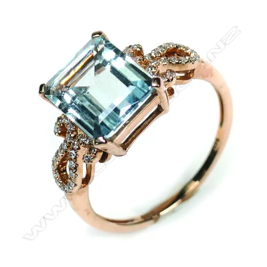 A 14k rose gold aquamarine and diamond ring