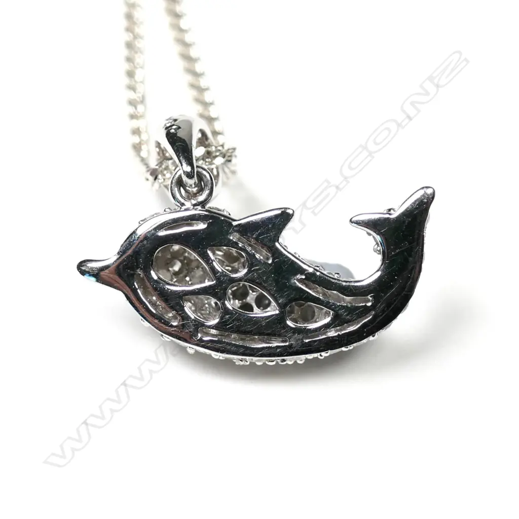 A 9ct white gold diamond set dolphin pendant Image 1++