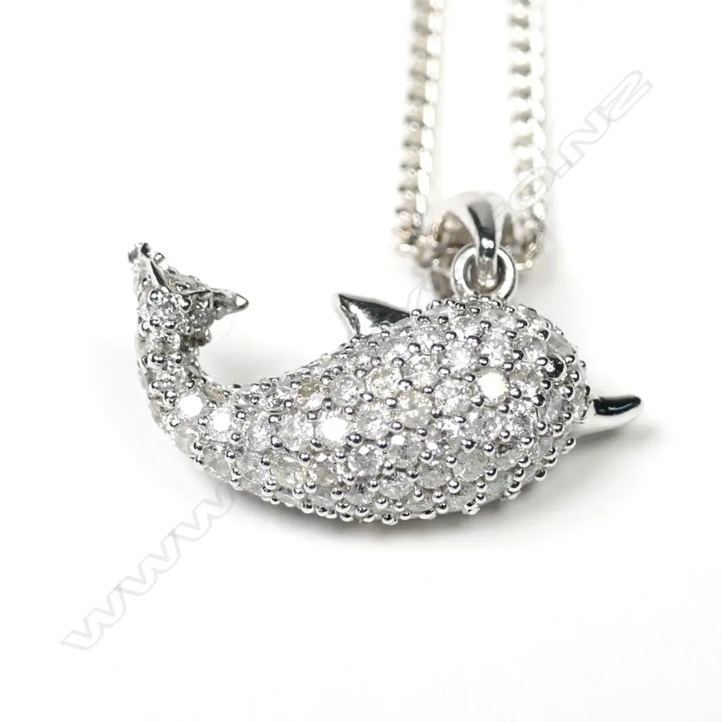 A 9ct white gold diamond set dolphin pendant Image 1++