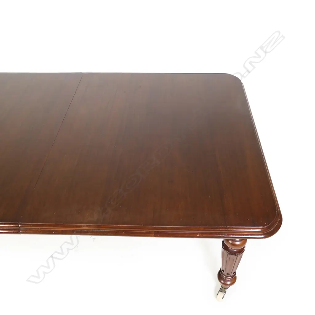 A Victorian mahogany banquet table with four leaves extends to seat twelve Image 1++