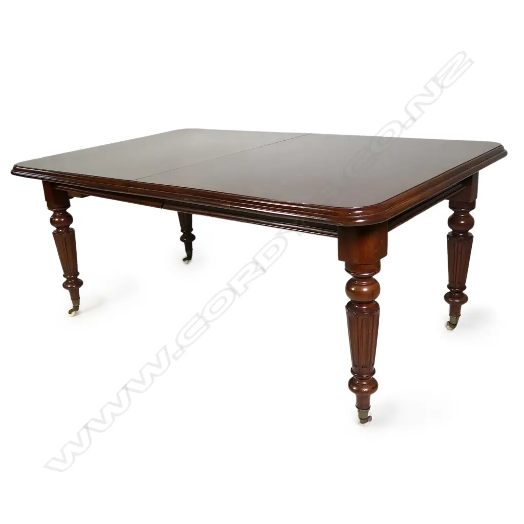 A Victorian mahogany banquet table with four leaves extends to seat twelve Image 1++