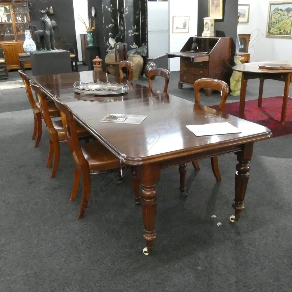 A Victorian mahogany banquet table with four leaves extends to seat twelve Image 1++