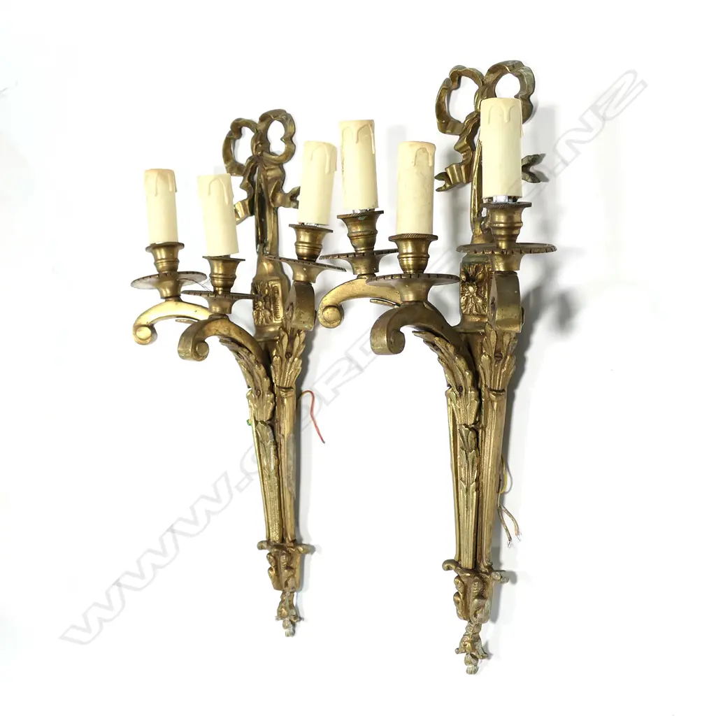 A pair of gilt brass three-light wall sconces Image 1++