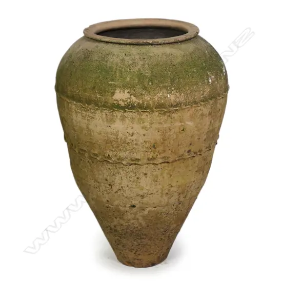 An old European terracotta tall olive oil storage jar