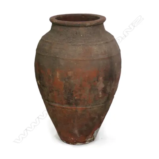 An old European terracotta tall olive oil storage jar