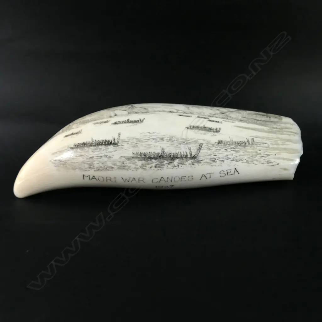 A 20thC finely scrimshawed ivory whales’ tooth 'Maori War Canoes at Sea 1827' Image 1++