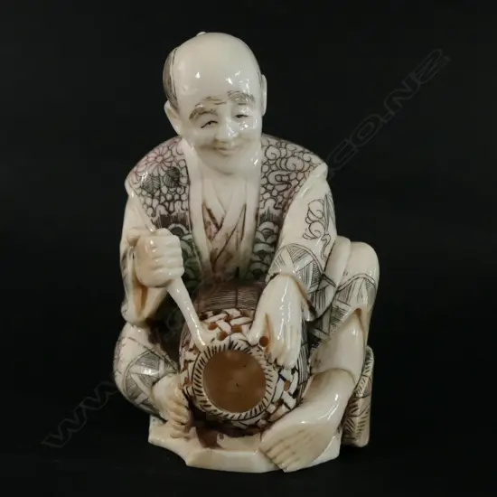 A Japanese ivory carving of a basket maker