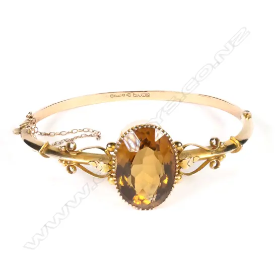 An early 1900s 9ct rose gold and citrine bangle