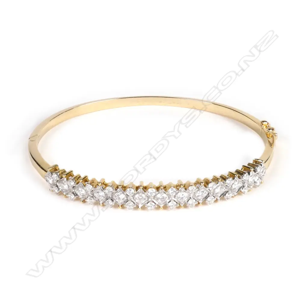 An 18ct yellow gold and diamond half hinged bangle Image 1++