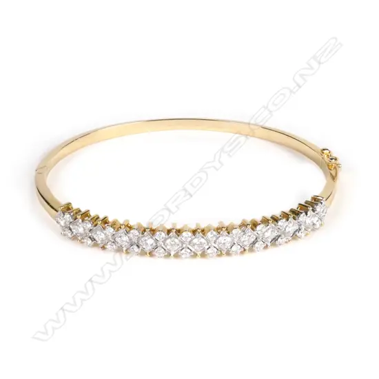 An 18ct yellow gold and diamond half hinged bangle