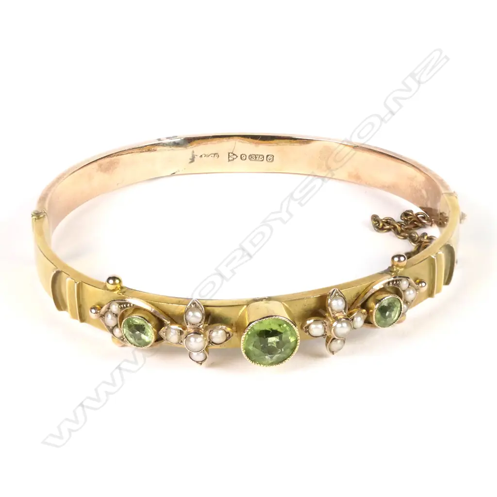 An early 1900s 9ct rose gold peridot and pearl bangle Image 1++