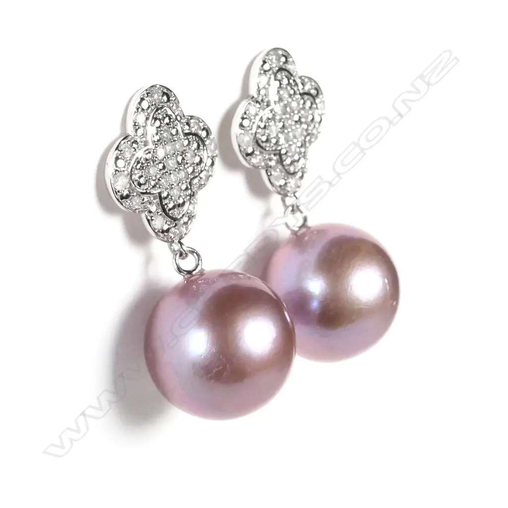 A pair of 14ct white gold pearl and diamond drop earrings Image 1++