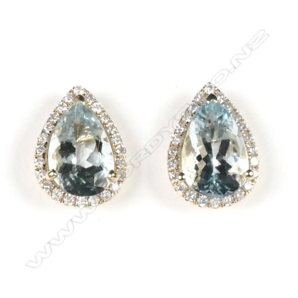 A pair of 14ct yellow gold aquamarine and diamond halo stud earrings Image 1++